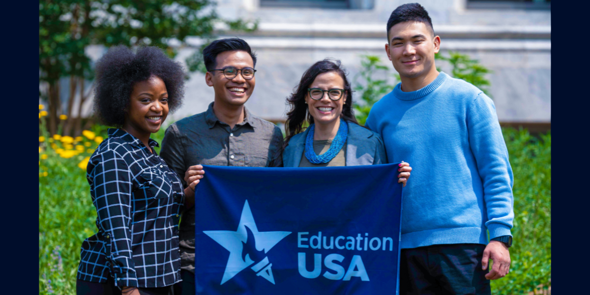 smiling young people hold EducationUSA banner