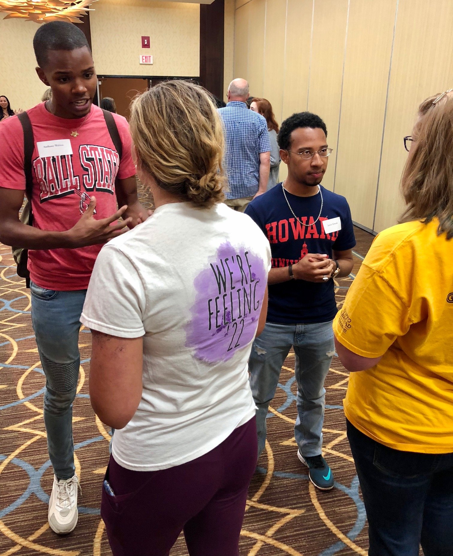 Four students standing and talking