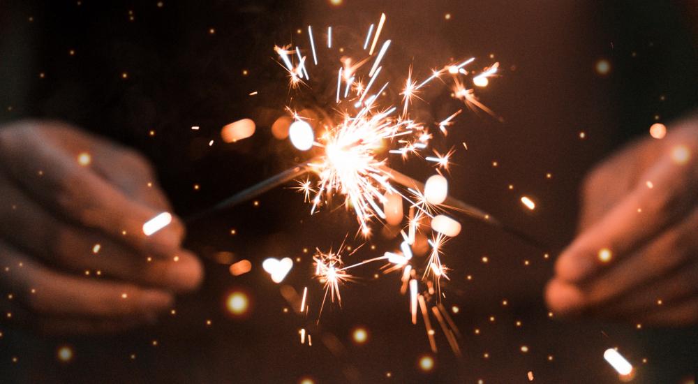 Two hands holding sparklers