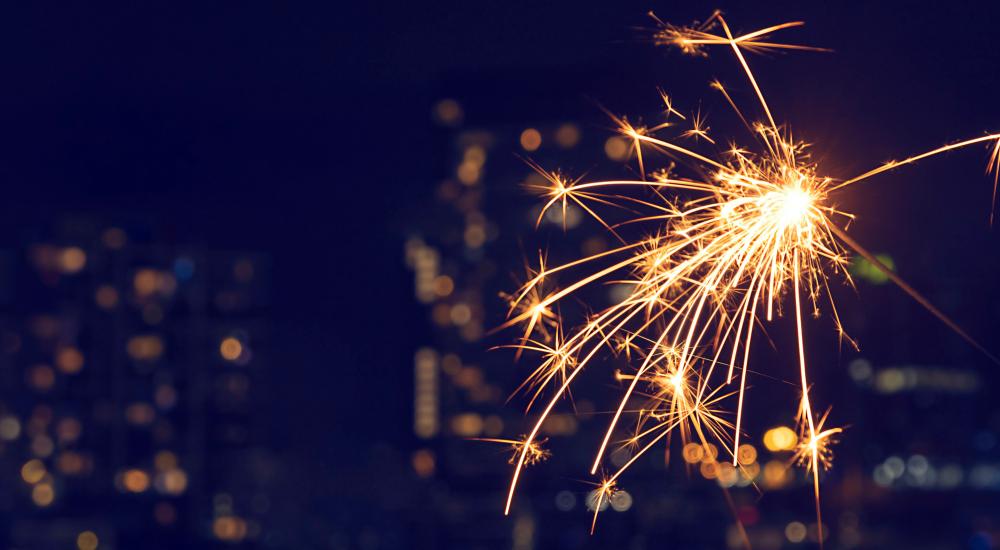 Sparkler with a city in the background