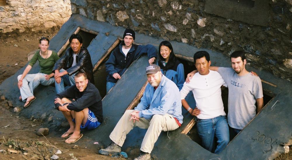 A group of students pose near a self-composting latrine they constructed.