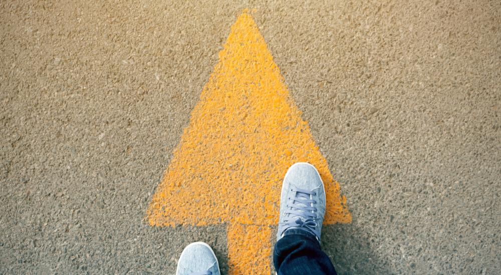 arrow on a road with feet