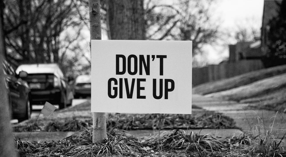 Yard sign that says, Don't Give Up