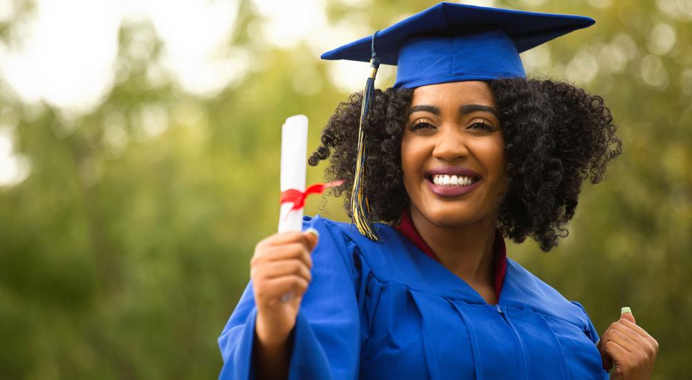 Photo of a graduate holding a diploma