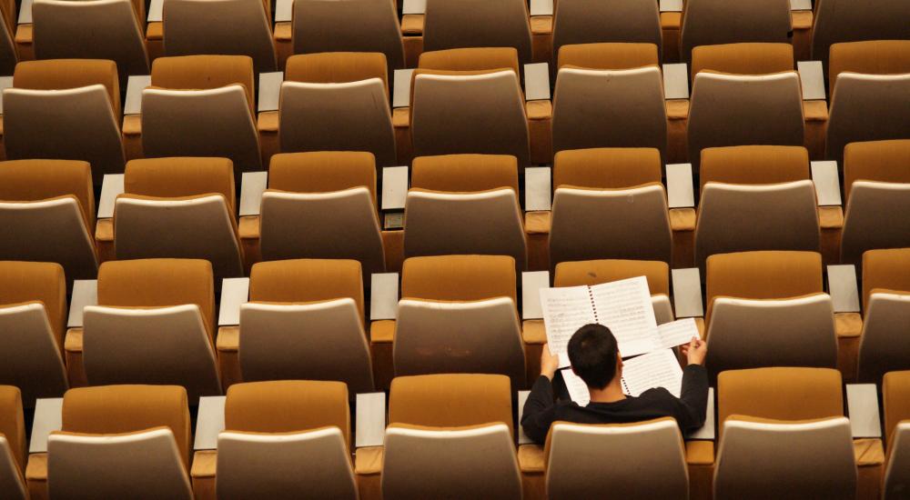 Person sitting alone in a classroom