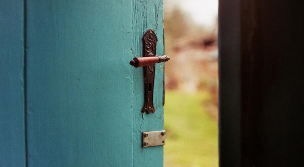 Photo of a blue door opening to the outside