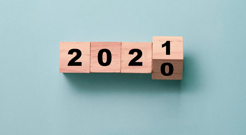 wooden blocks on a blue background turning from 2020 to 2021