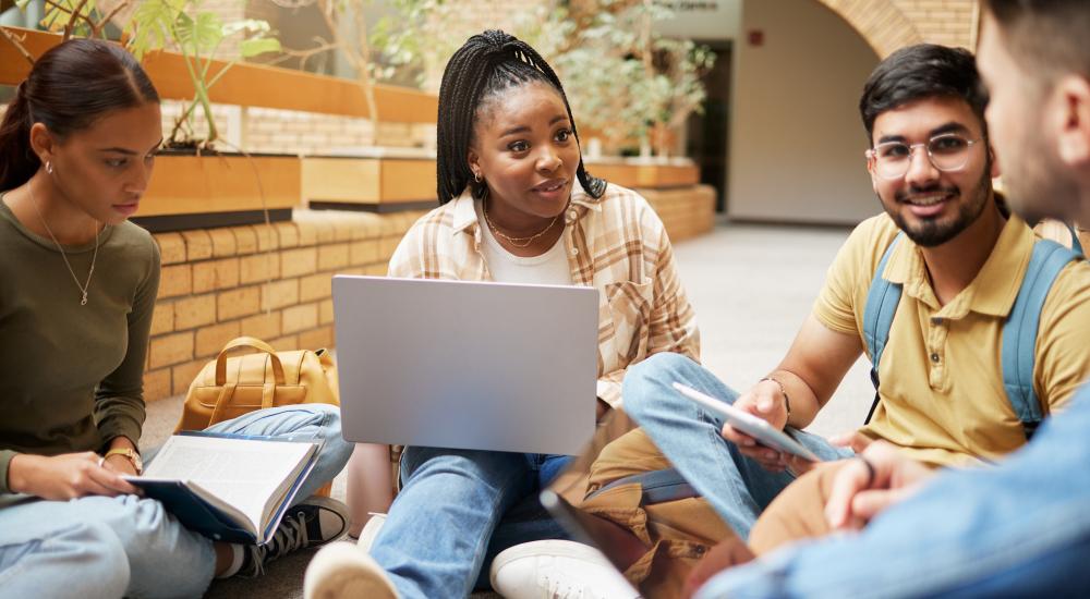 Group of students sitting outside talking