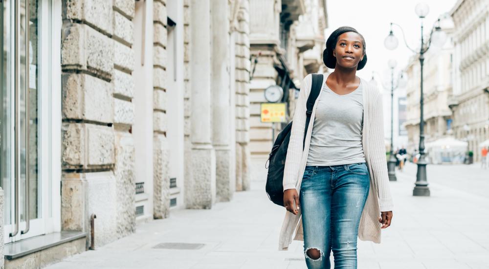 Photo of a student walking down the street