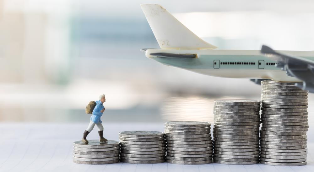 small figuring climbing piles of silver coins in front of toy plane