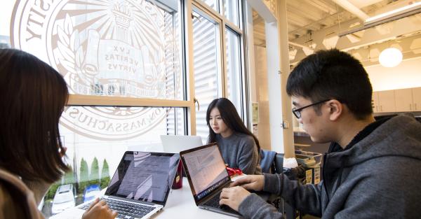 Students study in the atrium of Northwest University's Seattle campus