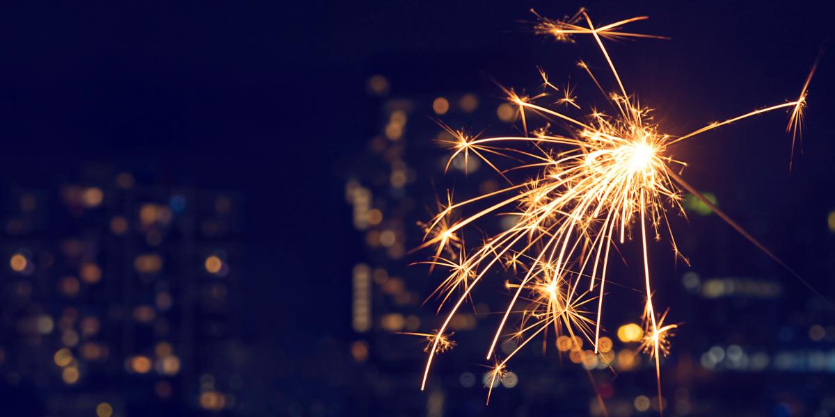 Sparkler with a city in the background