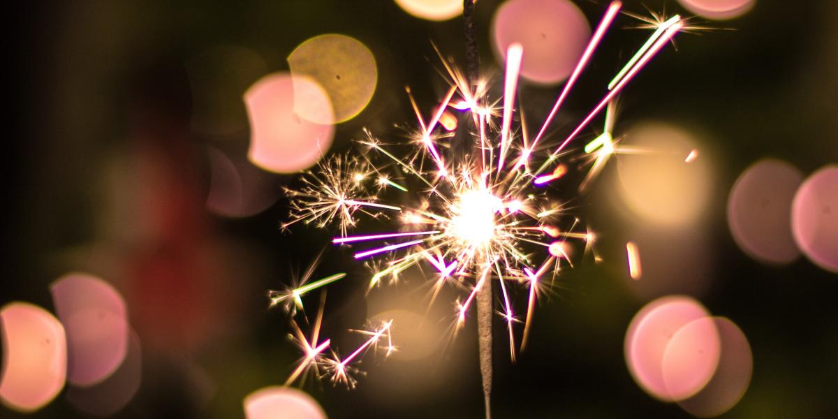 Pink sparkler on black background