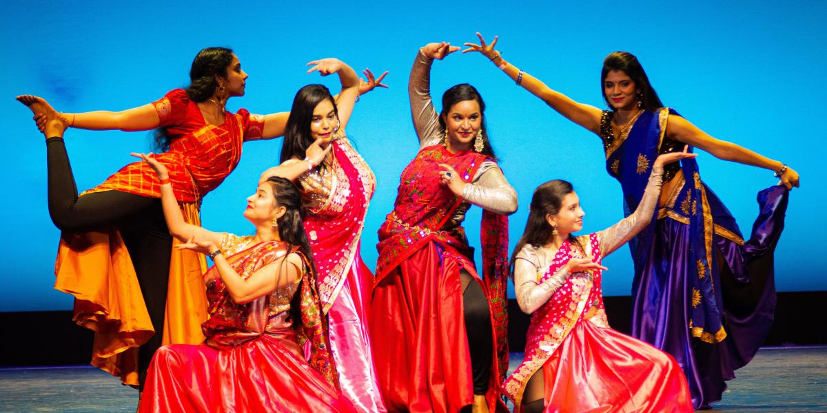 Indian students performing a dance on a stage