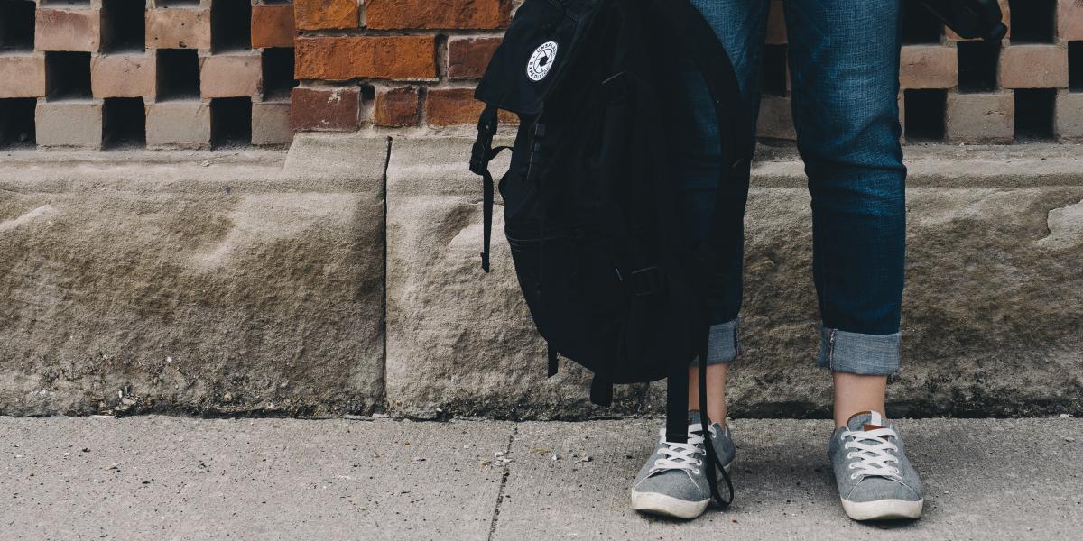 Student holding a backpack