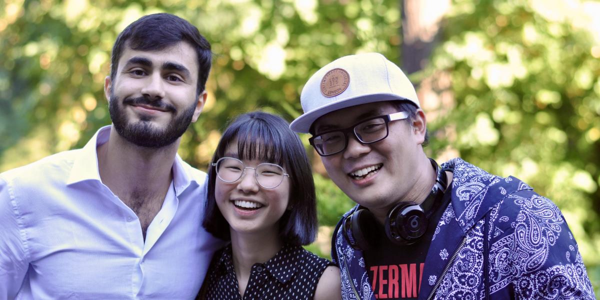 Three students smiling