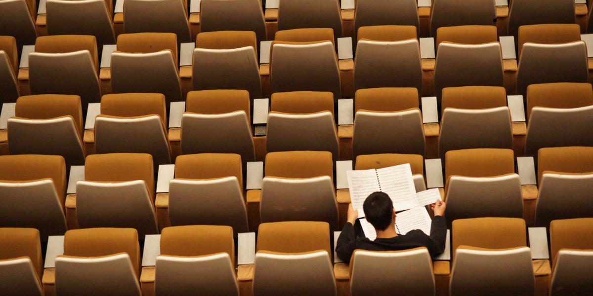 Person sitting alone in a classroom