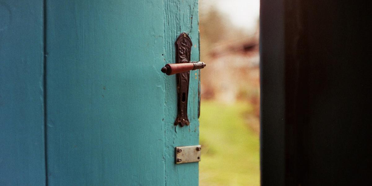 Photo of a blue door opening to the outside