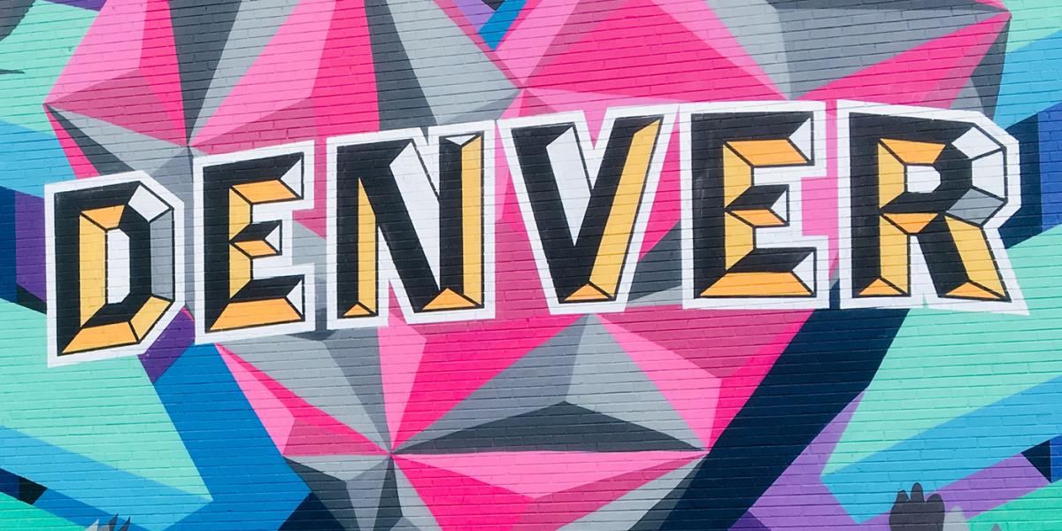 multicolored mural with "Denver" painted on a wall.