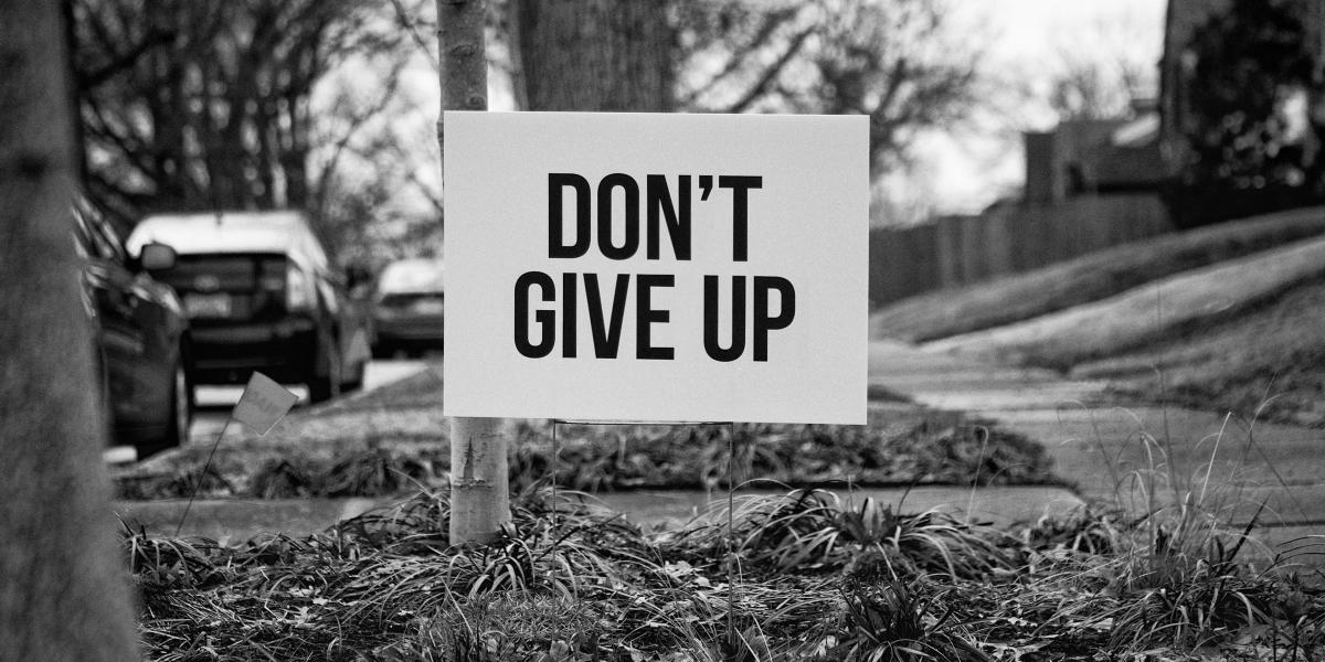 Yard sign that says, Don't Give Up