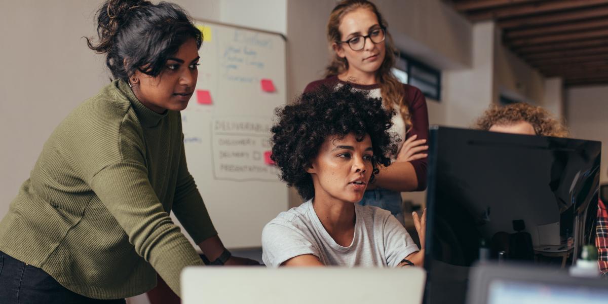 Group of coworkers looking at a computer screen