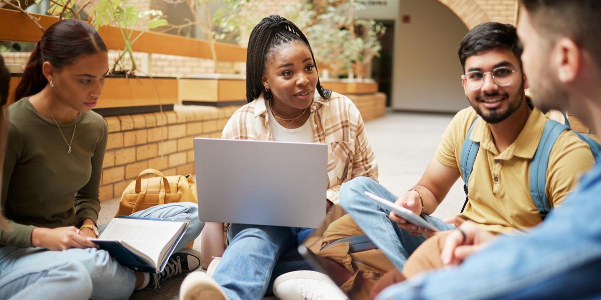 Group of students sitting outside talking