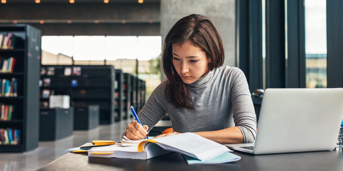 Young woman studying in library