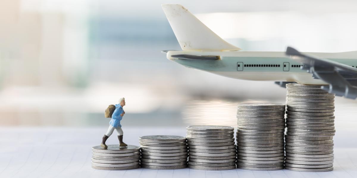 small figuring climbing piles of silver coins in front of toy plane