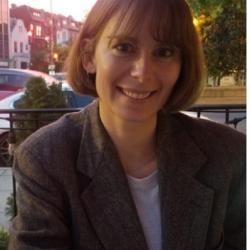 Headshot of smiling woman sitting outside