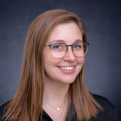 woman with reddish blonde hair smiling at the camera