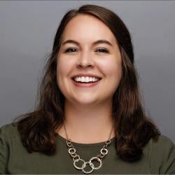 Chelsi smiles, wearing a green shirt