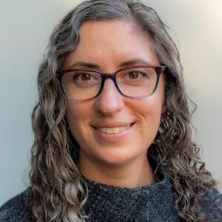 profile photo of a woman smiling and wearing glasses