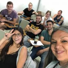 a group of students inside a classroom taking a selfie