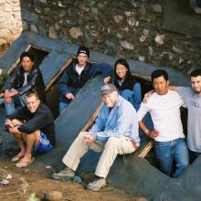 A group of students pose near a self-composting latrine they constructed.