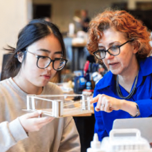 A professor and an international student work together in an architecture lab.