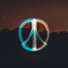 long exposure photograph of peace sign in light