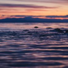 Sunset over water and rocks
