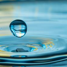 closeup of water droplet and ripple in water