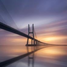 Photo of a bridge against a purple sky