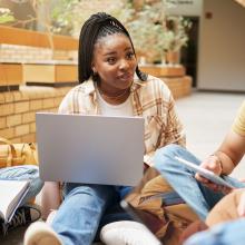 Group of students sitting outside talking