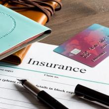 travel documents and insurance forms on a desk