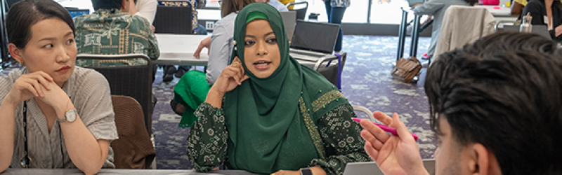 Management Development Program participants discuss topics around a table