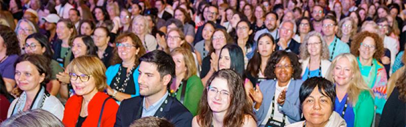 Conference attendees watching a plenary presentation